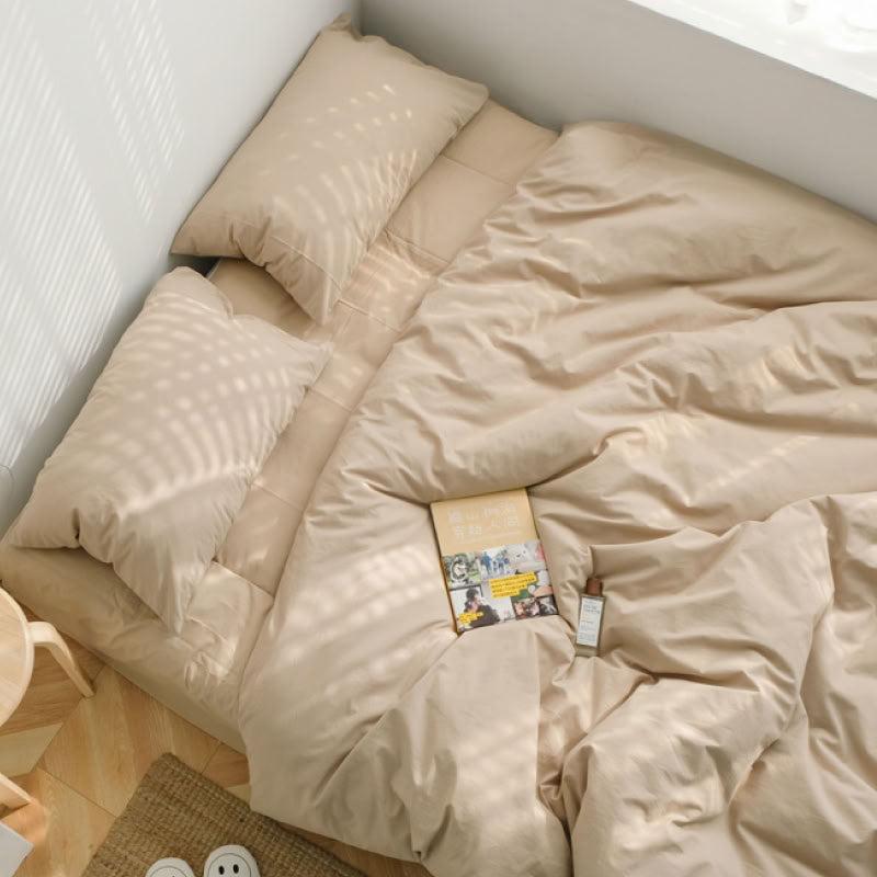 Soft Khaki Beige washed cotton bedding set with a book and warm natural light - RoomDen