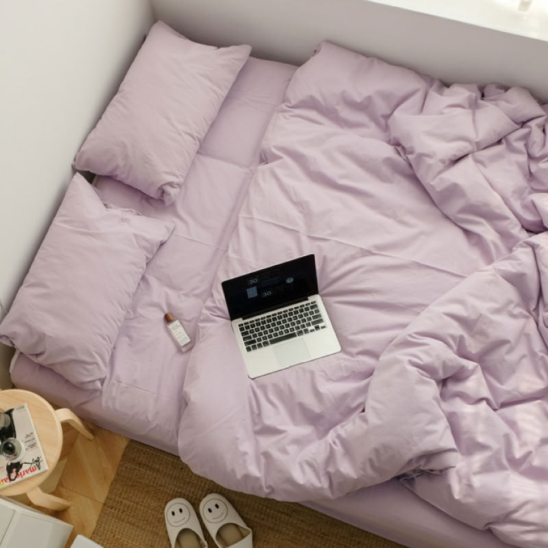 Soft Lavender washed cotton bedding set with a book and warm natural light - RoomDen