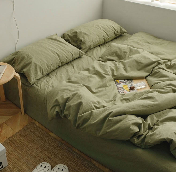 Pistachio Green washed cotton bedding set with pillows and a cozy minimalist setup - RoomDen