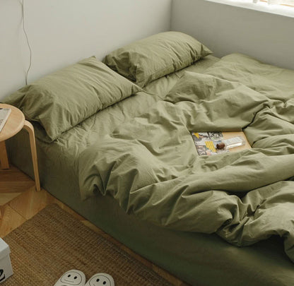 Pistachio Green washed cotton bedding set with pillows and a cozy minimalist setup - RoomDen