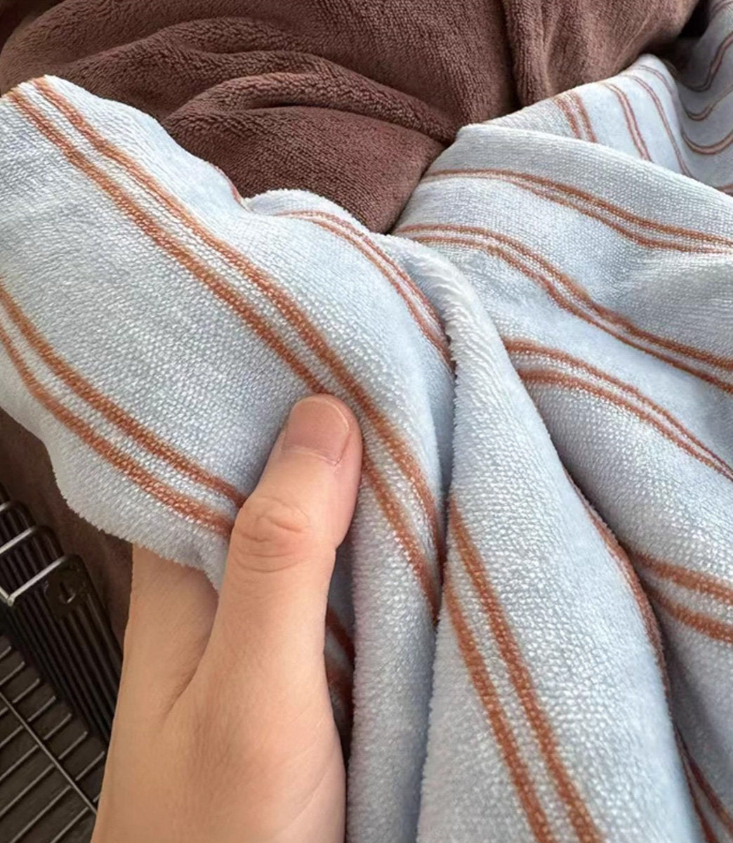 Close-up of Solid Brown Flannel Fleece pillowcase and fine striped duvet cover, showcasing the mix and match desi - RoomDen