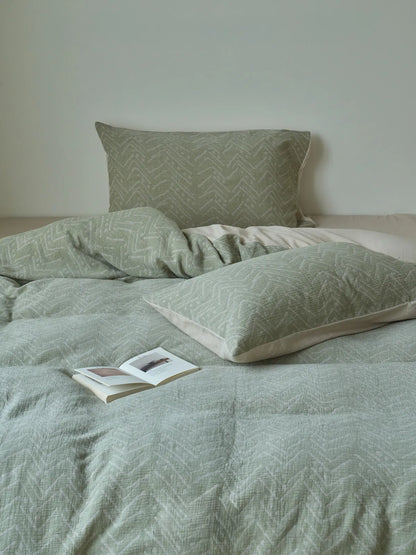 Front view of messy cozy sage green bedding set with crinkled texture RoomDen.