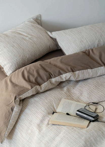 Soft washed cotton duvet cover with irregular pinstripes and messy bed look RoomDen.
