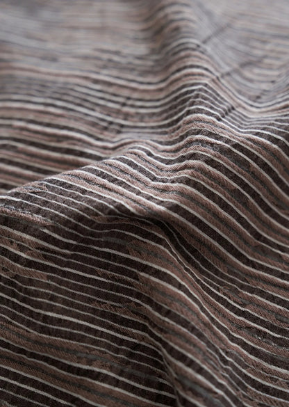 Extreme close up of washed cotton fabric weave and brown pinstripe detail RoomDen.