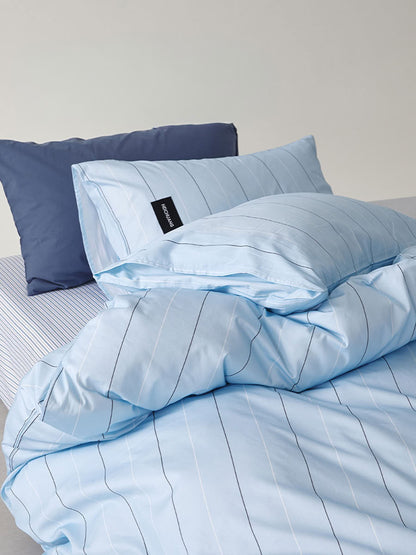 Close-up of light blue washed cotton duvet cover with fine pinstripe pattern – RoomDe