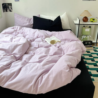 Light purple duvet and black sheet bedding in minimal cozy aesthetic setup – RoomDen