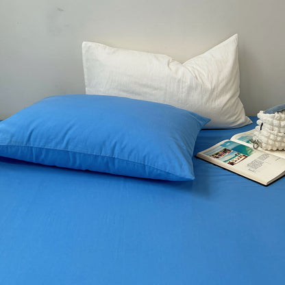 Soft cotton blue pillow and white pillowcase combination on solid bedding – RoomDen