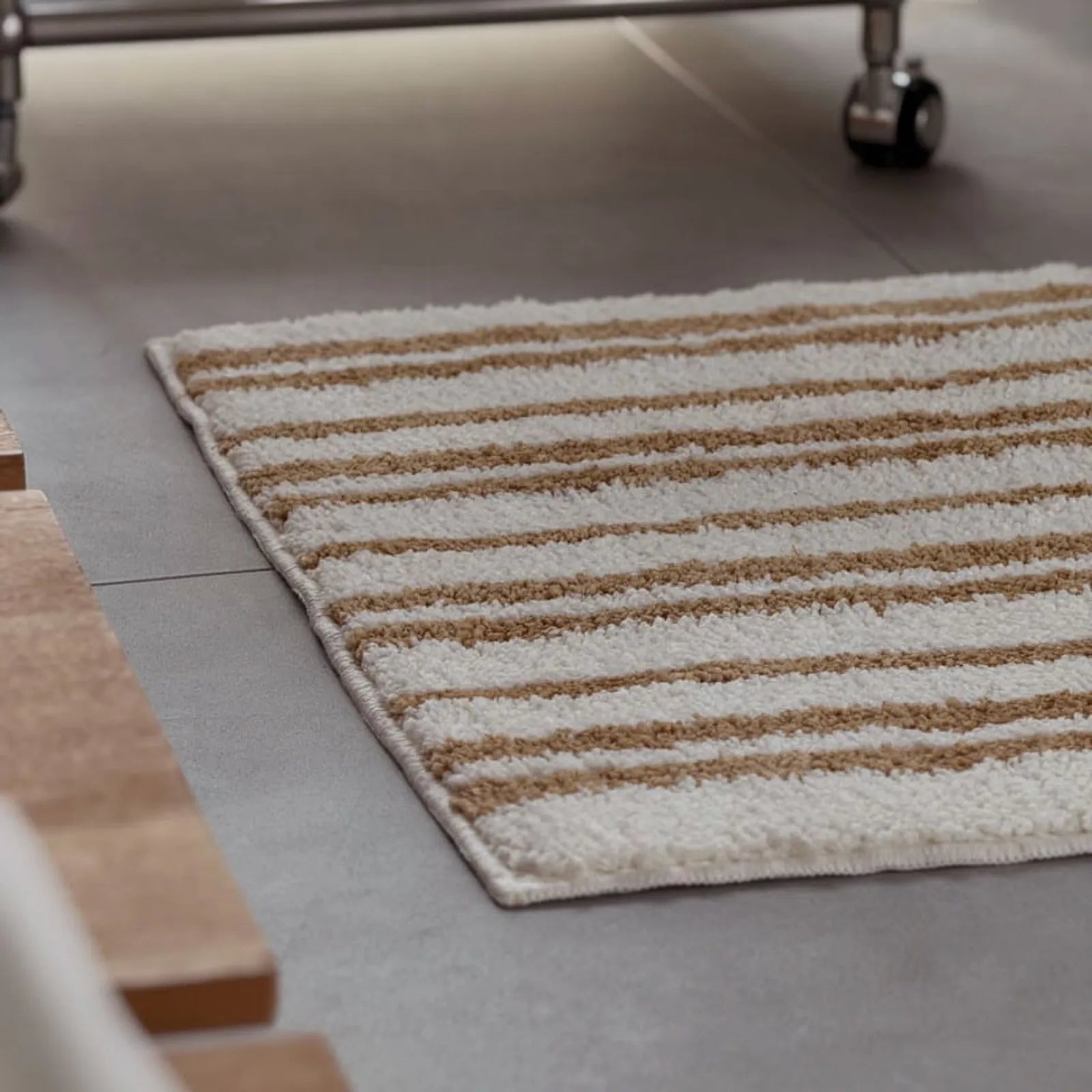 Close-up texture shot showing the fluffy pile of the caramel striped rug - RoomDen