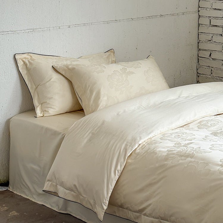Ondine Floral Cotton Blend Bedding Set – plain ivory reverse turned back over the floral duvet - Roomden
