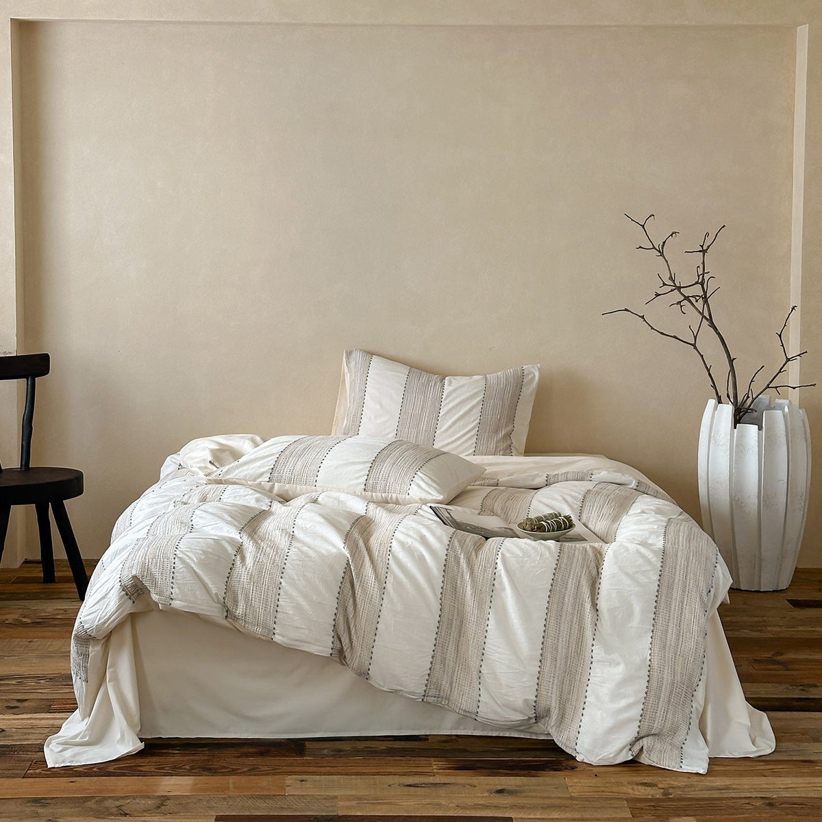 Solmere Striped Waffle-Weave Cotton Bedding Set – ivory stripe full bed arranged beside a tall vase - Roomden