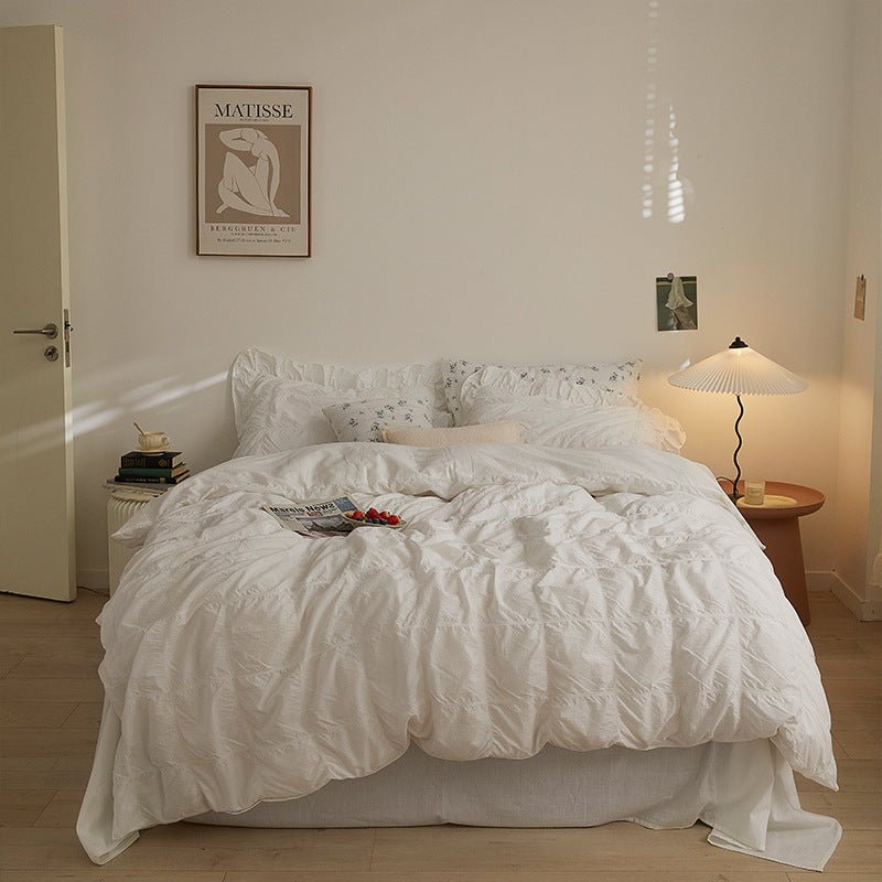 Odessa Ruffled Cotton Blend Bedding Set – full ivory bed with ruffled fabric beneath framed artwork - Roomden