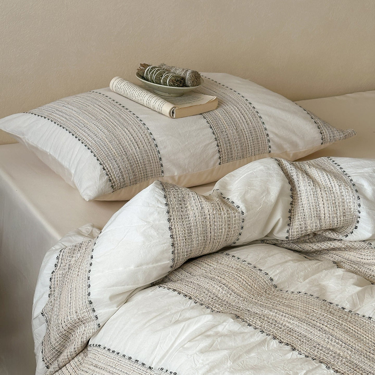 Solmere Striped Waffle-Weave Cotton Bedding Set – ivory stripe striped pillow resting on the textured duvet - Roomden