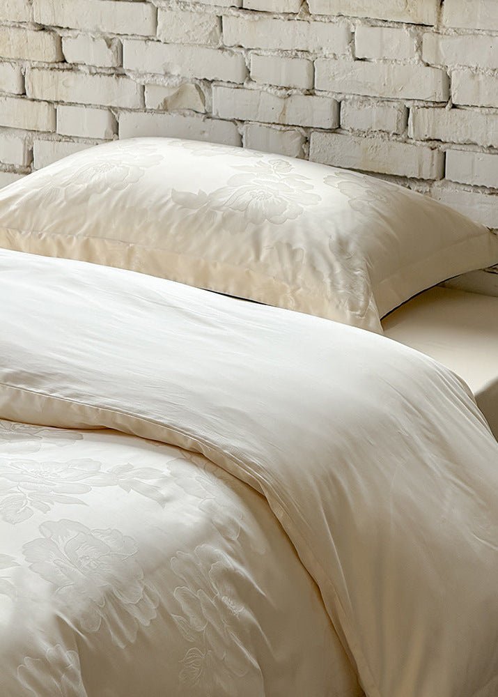 Ondine Floral Cotton Blend Bedding Set – close view of ivory floral fabric and a matching pillow - Roomden