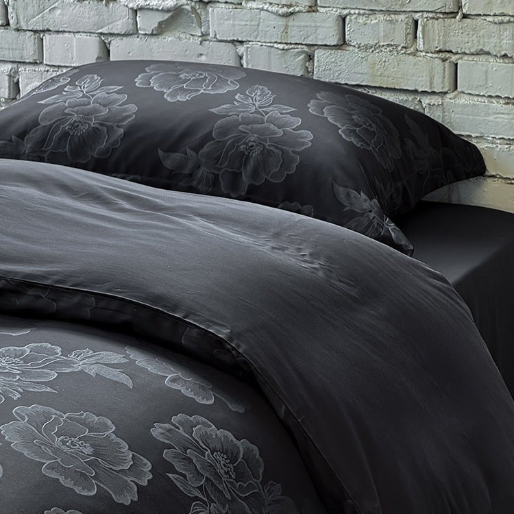 Ondine Floral Cotton Blend Bedding Set – close view of tonal flowers on the black duvet and pillow - Roomden