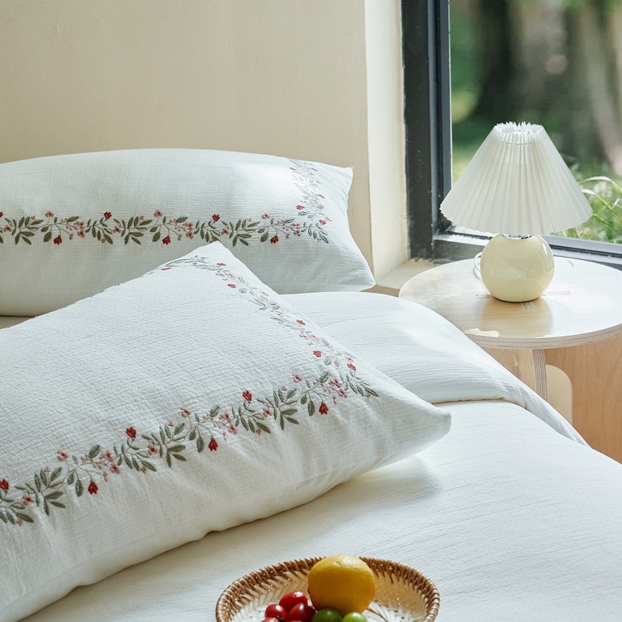 Ivory gauze bedding with green vine embroidery detail - Roomden