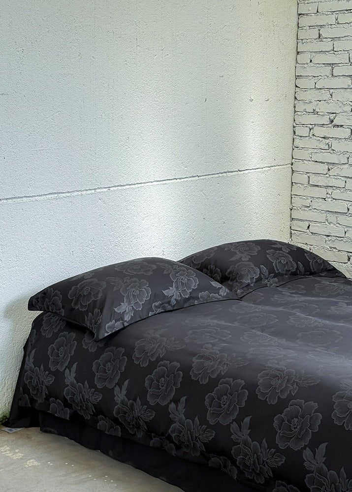 Ondine Floral Cotton Blend Bedding Set – black floral duvet spread below matching pillows - Roomden