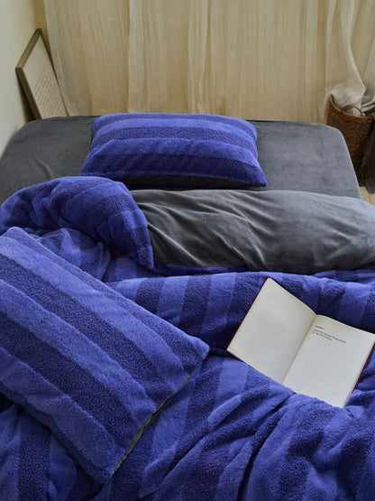 Blue wide striped plush fleece bedding set styled on grey sheet with cozy fluffy texture - RoomDen