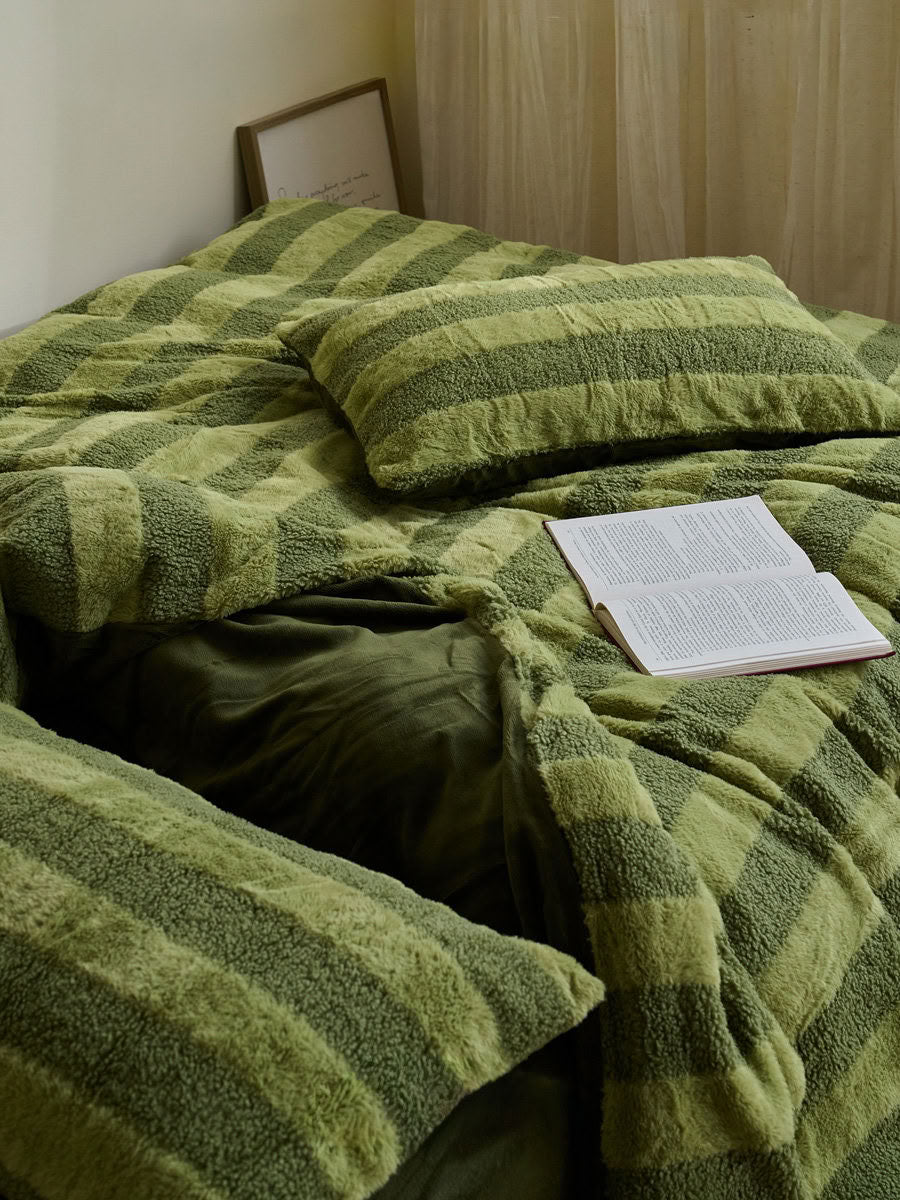 Folded plush fleece bedding set showing the wide stripe design and fluffy surface detail - RoomDen